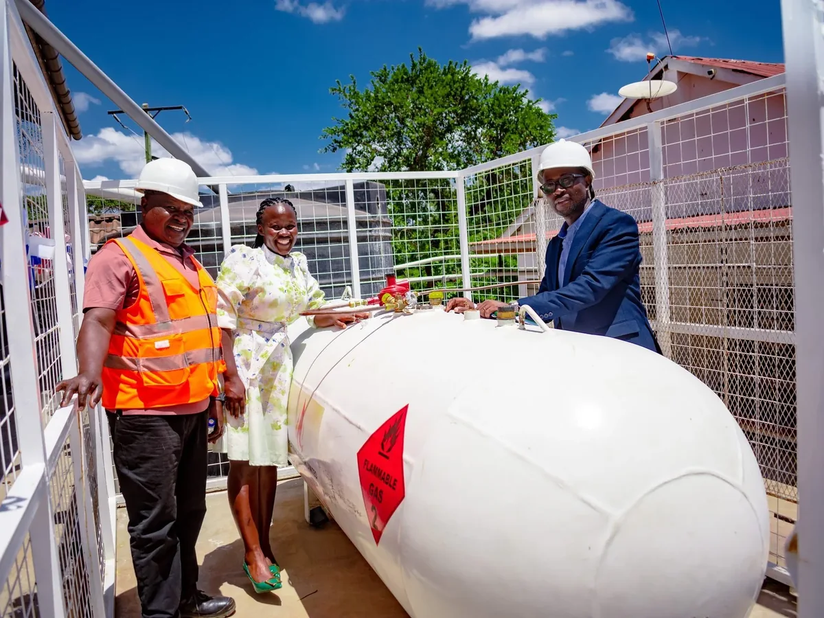 HeatMax Energy team members in safety helmets alongside an installed bulk LPG storage tank