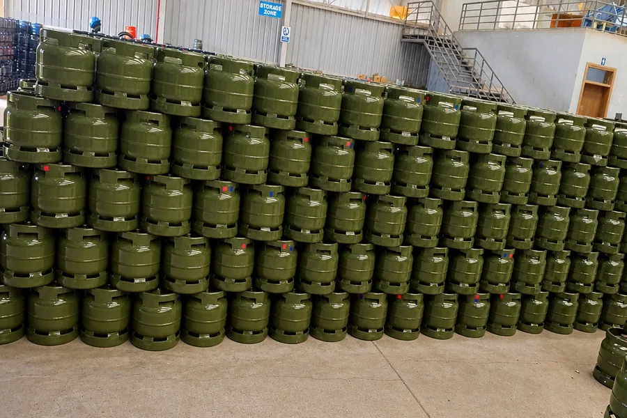 Stacked green 6kg LPG cylinders in a warehouse storage area