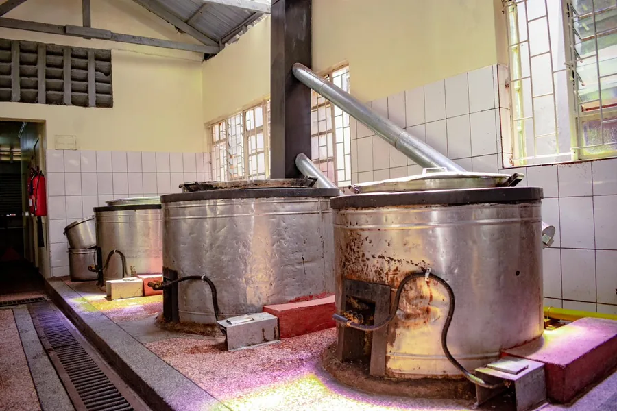 Institutional kitchen with LPG-fired cooking vessels and flue pipework