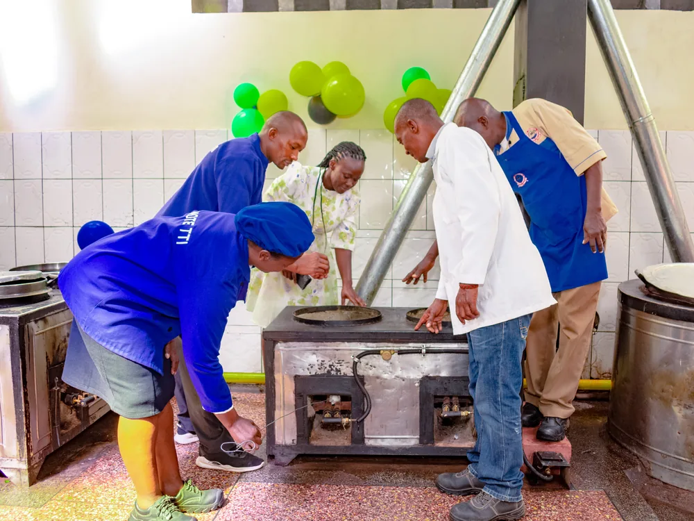 Kitchen staff and technicians at an institutional LPG cooking installation